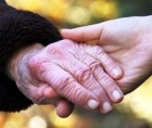 Joined hands of an older and a younger woman Joined hands of an older and a younger woman