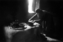 Ancient kitchen interior with woman serving food. Windows were small, interiors were dark. Ancient kitchen interior with woman serving food. Windows were small, interiors were dark.