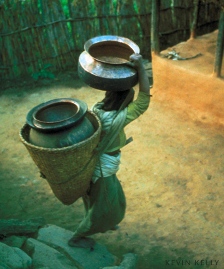 Bible study activities: Photograph by Kevin Kelly, woman carrying water containers