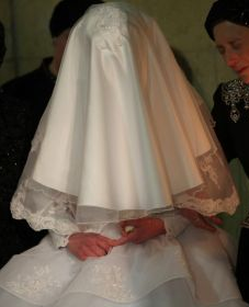 A fully veiled bride at her wedding