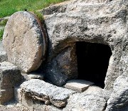 Stone tomb with circular door covering rolled away