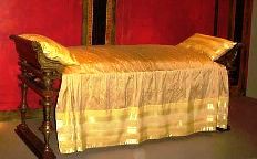 Reconstruction of a bed from ancient times, gold coverlet