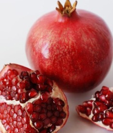 A pomegranate cut open to show the multiple seeds