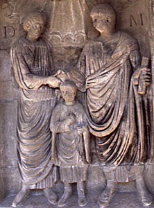 Image of a man, woman and child on a Roman family monument
