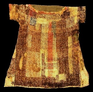 Children's clothes in ancient times. A child's garment found by archaeologists south of Cairo. It was woven from coloured wools as a single piece of cloth folded over at the shoulders, It appears to have been darned for recycling