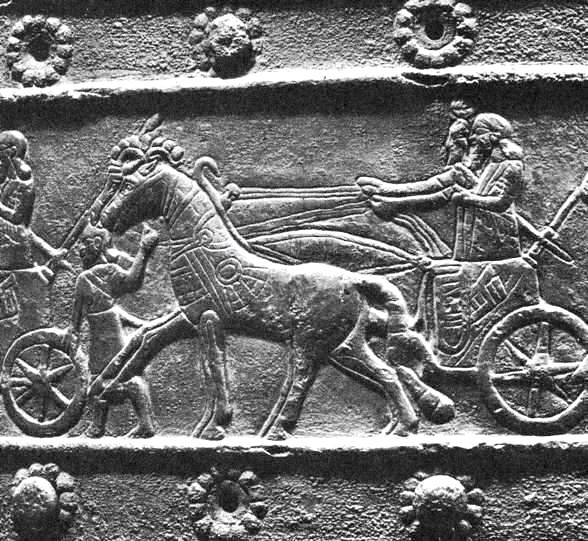 Wall carving of Assyrian chariot horses and their driver